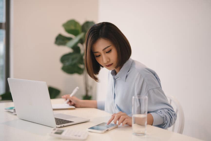 A young woman calculating her tax gains and losses.